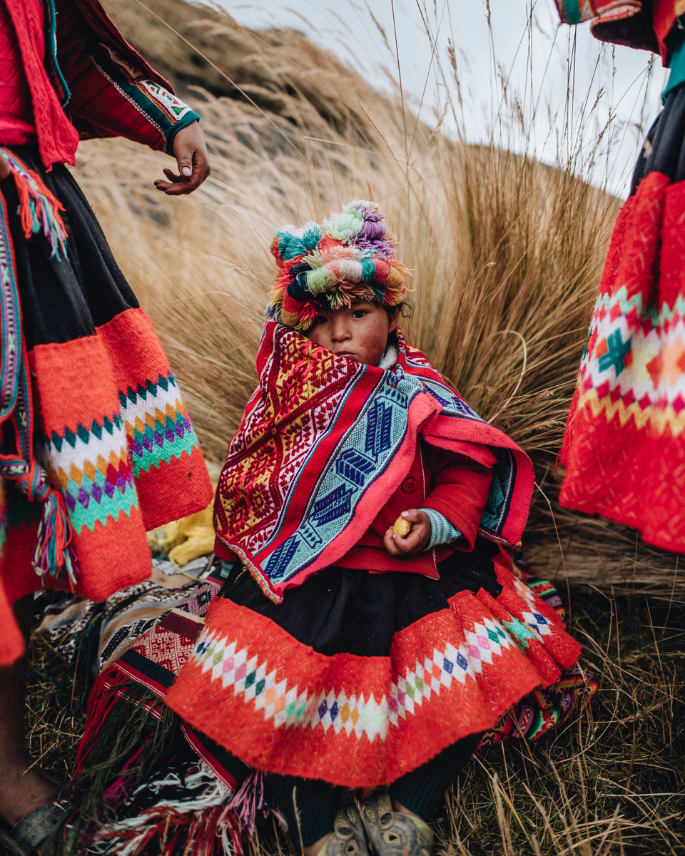 Little Peruvian girl in bright colored traditional costume