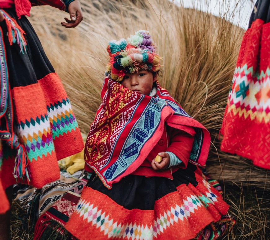 Little Peruvian girl in bright colored traditional costume